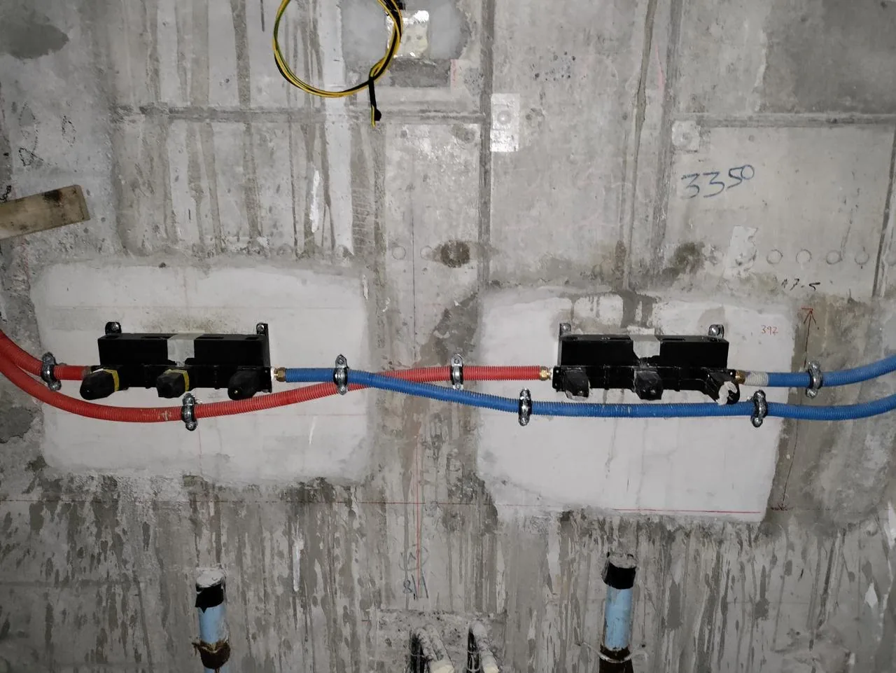 Hot and cold water pipes routed in a wall before finishing
